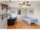 Bedroom featuring hardwood floors, a ceiling fan, a bed, a desk, and modern decor with shelves at 1898 Woodland Hills Nw Ave, Atlanta, GA 30318