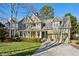 Charming two-story home with manicured front yard and inviting covered porch at 1898 Woodland Hills Nw Ave, Atlanta, GA 30318