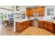 Well-lit kitchen featuring stainless steel appliances, wooden cabinets, light countertops, and hardwood floors at 1898 Woodland Hills Nw Ave, Atlanta, GA 30318