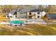 Aerial of backyard featuring in-ground pool, cabana, lounge chairs, firepit, and lush grass at 2634 Greenes Ln, Powder Springs, GA 30127