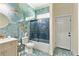 Stylish bathroom features blue marble walls, hexagon floors, shower with glass door, and a modern vanity at 2634 Greenes Ln, Powder Springs, GA 30127