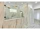 Modern bathroom featuring a luxurious, spacious marble tiled shower with dual shower heads and a built in shelf at 2634 Greenes Ln, Powder Springs, GA 30127