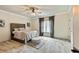 Bedroom features a queen-sized bed, an ottoman, a ceiling fan, and neutral decor at 2634 Greenes Ln, Powder Springs, GA 30127