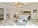 This bedroom boasts a bed, ottoman, ceiling fan, and neutral decor at 2634 Greenes Ln, Powder Springs, GA 30127