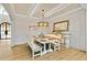 Charming dining room with classic wainscoting, a decorative chandelier, and an inviting farmhouse-style dining set at 2634 Greenes Ln, Powder Springs, GA 30127