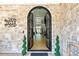 Elegant entryway with arched double doors, stone walls, and a view into the bright, open interior at 2634 Greenes Ln, Powder Springs, GA 30127