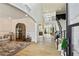 Grand foyer showcasing a high ceiling, an open staircase, light hardwood floors, and an arched entryway at 2634 Greenes Ln, Powder Springs, GA 30127