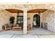 Inviting covered front porch with stone accents, comfortable seating, and stylish lighting fixtures at 2634 Greenes Ln, Powder Springs, GA 30127