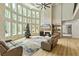 Bright, airy living room featuring large windows, a soaring ceiling, and a floor-to-ceiling stone fireplace at 2634 Greenes Ln, Powder Springs, GA 30127