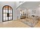 Bright living room featuring a large arched window and a cozy seating area with a stylish rug at 2634 Greenes Ln, Powder Springs, GA 30127