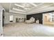 Large main bedroom showcasing dark accent wall, tray ceilings, chandelier, and carpeted floor at 2634 Greenes Ln, Powder Springs, GA 30127