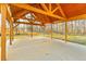 Wide shot of open pavilion with wooden beams and posts, set amongst a wooded backdrop at 2634 Greenes Ln, Powder Springs, GA 30127