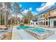 A backyard with a swimming pool and hot tub perfect for entertaining and relaxing at 2634 Greenes Ln, Powder Springs, GA 30127