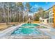 Resort-style pool with hot tub, waterfall feature, and lush landscaping at 2634 Greenes Ln, Powder Springs, GA 30127