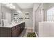 Modern bathroom featuring a double vanity with granite counters and a tiled shower with glass doors at 2720 Ravencliff Dr, Austell, GA 30168