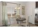 Bright breakfast nook featuring a round table, four chairs, and a window with patterned curtains at 2720 Ravencliff Dr, Austell, GA 30168