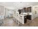 Modern kitchen featuring a large center island with seating, dark wood cabinets, and stainless steel appliances at 2720 Ravencliff Dr, Austell, GA 30168