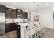 Well-lit kitchen features a center island with seating, pendant lights, and modern stainless-steel appliances at 2720 Ravencliff Dr, Austell, GA 30168