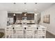 Spacious kitchen island with white countertop, seating, and dark wood cabinets with stainless steel appliances at 2720 Ravencliff Dr, Austell, GA 30168