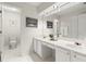 Bright bathroom featuring a double sink vanity, white tile flooring, large mirror and recessed lighting at 913 Thornington Pl, Roswell, GA 30075