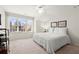 Bedroom features neutral colored walls, large window with blinds, ceiling fan, and a closet at 913 Thornington Pl, Roswell, GA 30075