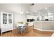 Bright breakfast nook with adjacent kitchen and white cabinet and hutch at 913 Thornington Pl, Roswell, GA 30075