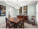 Dining room featuring chair rail, chandelier, and a dark wood table at 913 Thornington Pl, Roswell, GA 30075