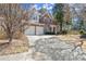 Exterior view of a brick two story home with a two car garage and driveway at 913 Thornington Pl, Roswell, GA 30075