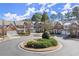 Residential street featuring brick townhomes with well-maintained lawns and landscaping at 913 Thornington Pl, Roswell, GA 30075