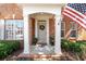 Inviting front porch with decorative wreath and American flag, creating a welcoming entrance at 913 Thornington Pl, Roswell, GA 30075