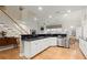 Bright kitchen with stainless steel appliances and adjacent breakfast area and staircase at 913 Thornington Pl, Roswell, GA 30075