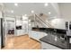 Bright kitchen with granite countertops, stainless steel appliances, and staircase in view at 913 Thornington Pl, Roswell, GA 30075