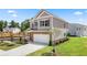 Two-story home showcasing a brick and gray siding exterior with a two-car garage and well-manicured landscaping at 1265 Elowen Dr, Austell, GA 30168