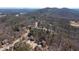 An aerial shot showing the neighborhood and surrounding wooded area with view of a lake in the distance at 15 York Trce, Cartersville, GA 30121