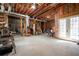 Unfinished basement with exposed beams, ductwork, and a door to the outside, offering potential for customization at 15 York Trce, Cartersville, GA 30121