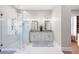 Bathroom featuring a glass shower, double sinks, and elegant white cabinets at 15 York Trce, Cartersville, GA 30121