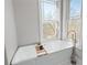 Soaking tub near two large windows offers a peaceful view of the outdoors at 15 York Trce, Cartersville, GA 30121