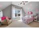 Bright bedroom with sloped ceilings, pink accents, and large windows offering natural light at 15 York Trce, Cartersville, GA 30121