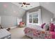 Cozy bedroom with sloped ceilings, playful polka dots, and a comfortable seating area at 15 York Trce, Cartersville, GA 30121