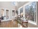 Bright breakfast nook with hardwood floors, a bistro table, and picturesque backyard views through large windows at 15 York Trce, Cartersville, GA 30121