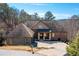 Charming home boasting a brick and stone exterior with a covered porch and circular driveway at 15 York Trce, Cartersville, GA 30121