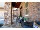 Inviting covered front porch featuring stone pillars, brick accents, and stylish seating at 15 York Trce, Cartersville, GA 30121