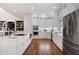 Bright kitchen boasts white cabinetry, stainless appliances, and hardwood floors at 15 York Trce, Cartersville, GA 30121