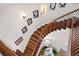 Elegant curved staircase showcasing wood treads, iron spindles, and decorative wall art at 15 York Trce, Cartersville, GA 30121