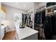 Spacious walk-in closet with custom shelving, an island with seating and natural light at 15 York Trce, Cartersville, GA 30121