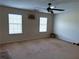 A bright bedroom with two windows, carpet, and a ceiling fan at 3134 Imperial Sw Cir, Atlanta, GA 30311