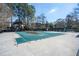 Large, covered community pool surrounded by mature trees and landscaping at 54 Monet Nw Ct, Atlanta, GA 30327