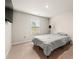 A carpeted bedroom bathed in natural light from its window, featuring a sleek, wall-mounted TV for entertainment at 1695 Beckworth Ln, Hampton, GA 30228