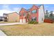 Side view of a beautiful brick home showcasing a spacious driveway and manicured lawn at 1695 Beckworth Ln, Hampton, GA 30228