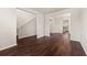 Open-concept living room with hardwood floors and neutral paint at 1695 Beckworth Ln, Hampton, GA 30228